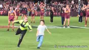 See the hilarious moment footy stars are busted cheering on boy who made security guard look silly when he ran onto the field at AFL match