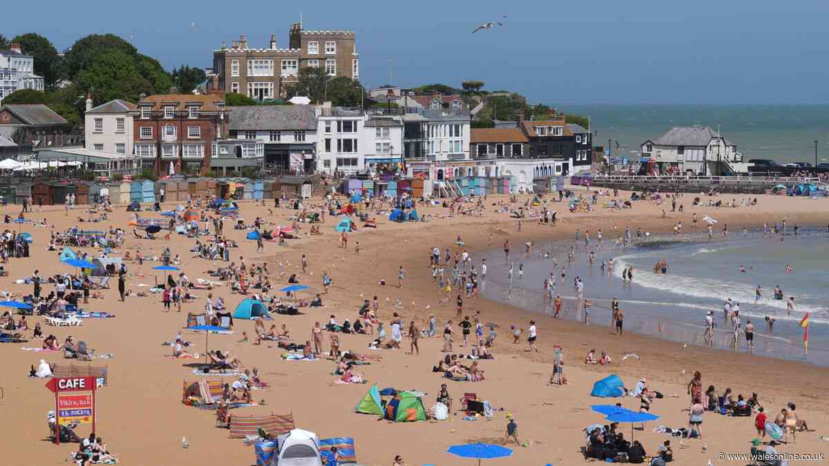 Two men die after entering sea where children were in difficulty during UK heatwave