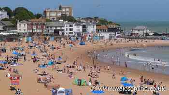 Two men die after entering sea where children were in difficulty during UK heatwave