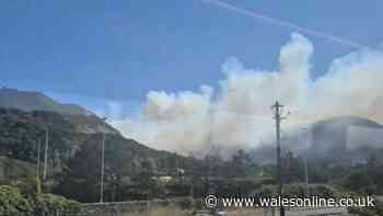 Smoke billows from mountainside as firefighters continue to battle blaze - live updates