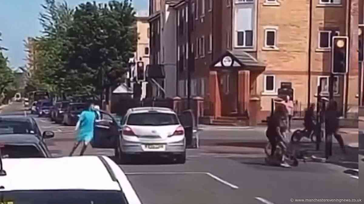 Chaos erupts at Manchester traffic lights as e-bike riders clad in balaclavas launch machete attack on car