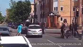 Chaos erupts at Manchester traffic lights as e-bike riders clad in balaclavas launch machete attack on car