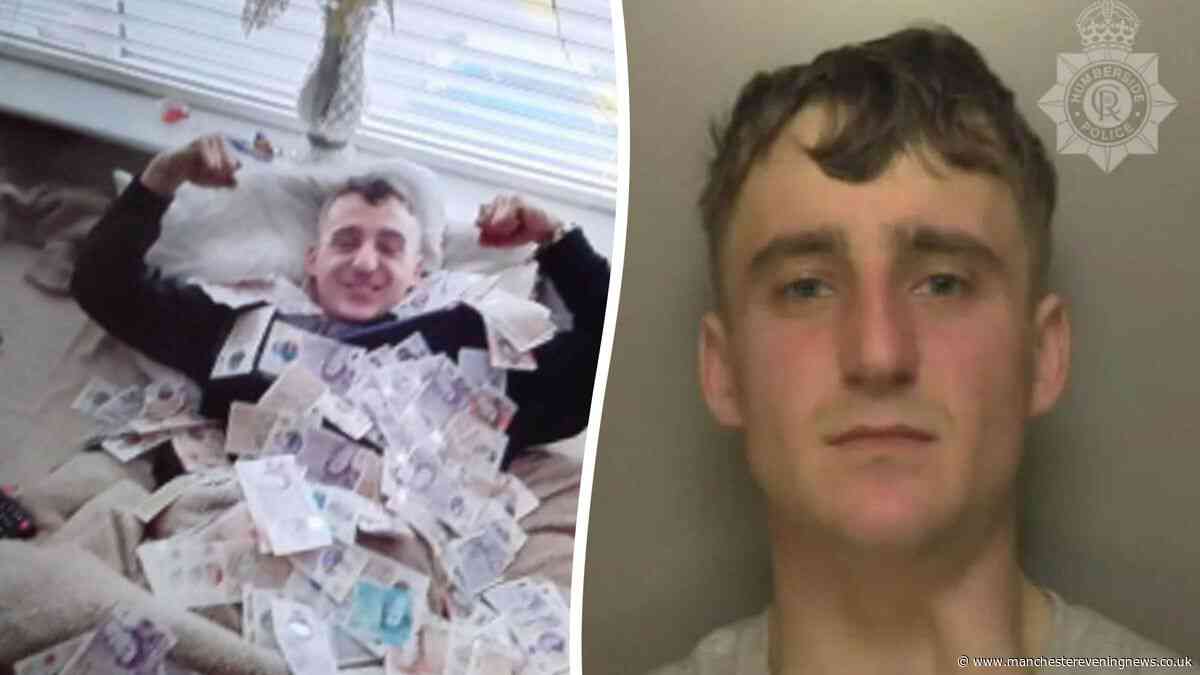 Drug dealer jailed after photographed posing beneath piles of cash