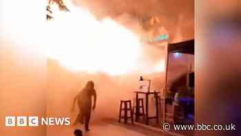 People flee Bangkok bar as huge flames shoot out from doorway