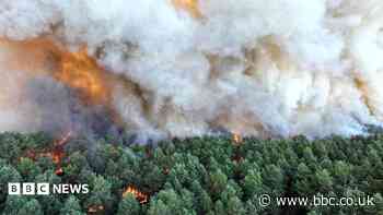 Wildfire raging south of Paris could have been set deliberately, says minister