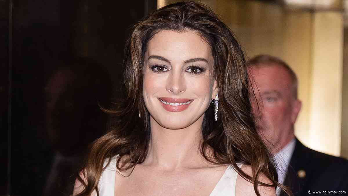 Pregnant Anne Hathaway, 43, glows in silk dress as she heads to Late Night with Seth Meyers in NY