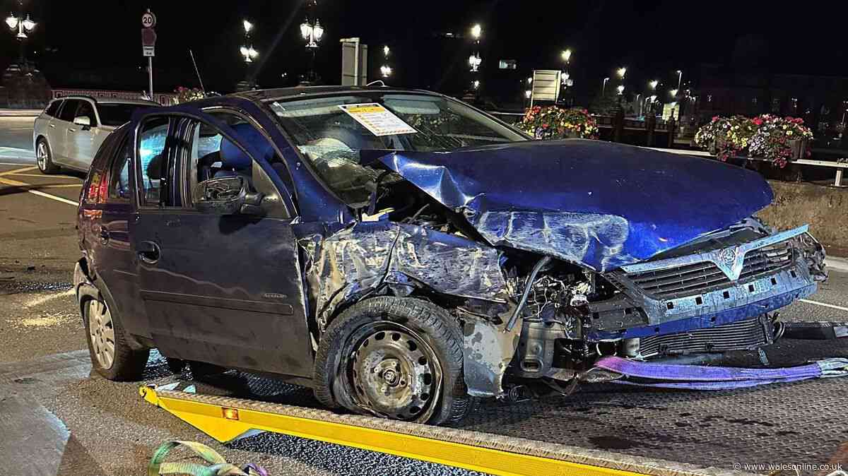 Car left a crumpled mess after crashing into roundabout during police chase