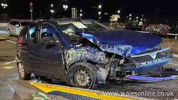 Car left a crumpled mess after crashing into roundabout during police chase