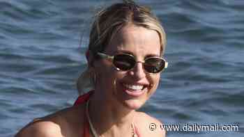 Pregnant Vogue Williams shows off her baby bump in a red bikini as Spencer Matthews lugs the bags to the beach on family holiday to Spain