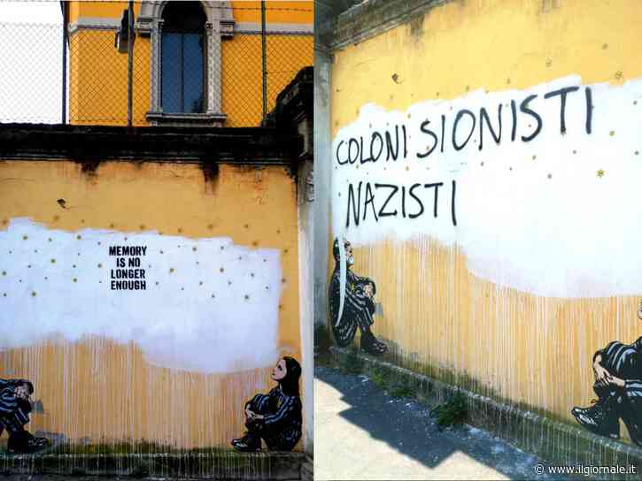 Gli estremisti sfregiano anche la Shoah, imbrattato il murale della memoria a Milano: “Coloni sionisti nazisti”