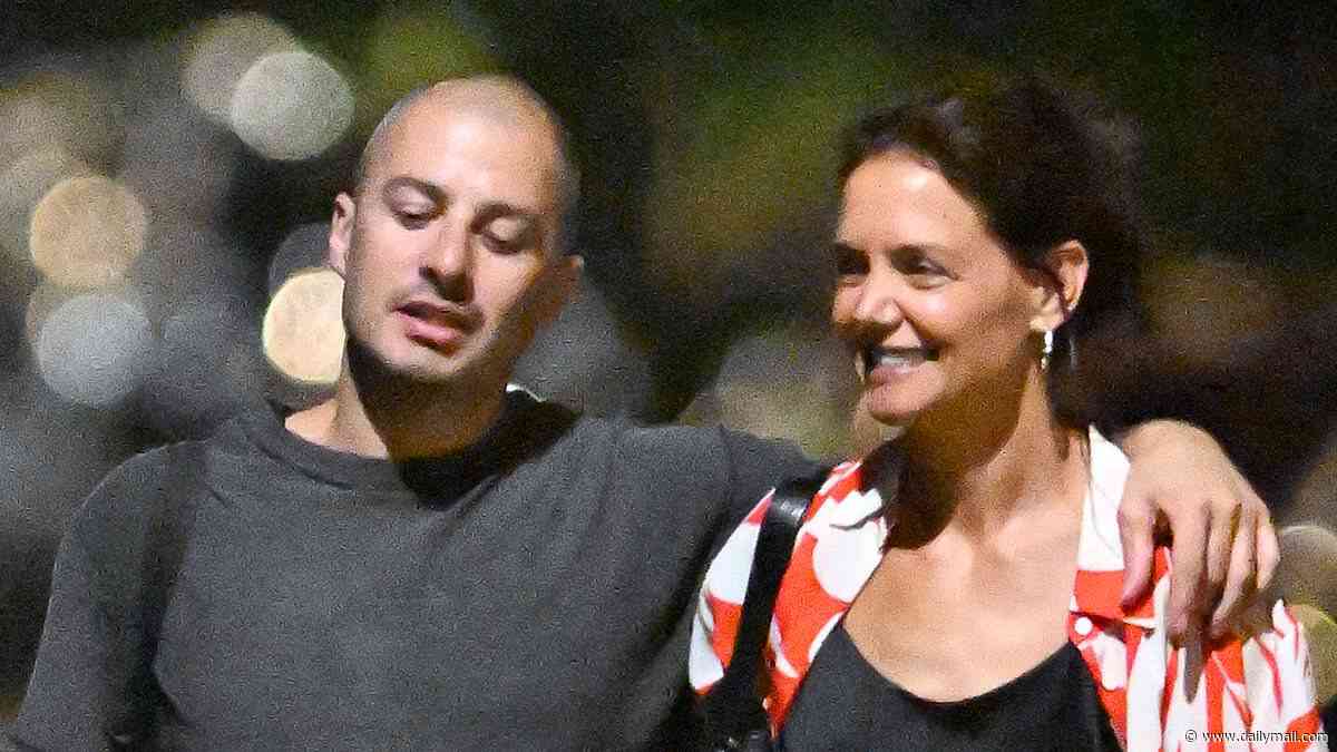 Katie Holmes cheekily pats much-younger new love's behind as they CONFIRM romance on giddy NYC stroll