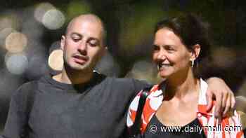 Katie Holmes cheekily pats much-younger new love's behind as they CONFIRM romance on giddy NYC stroll