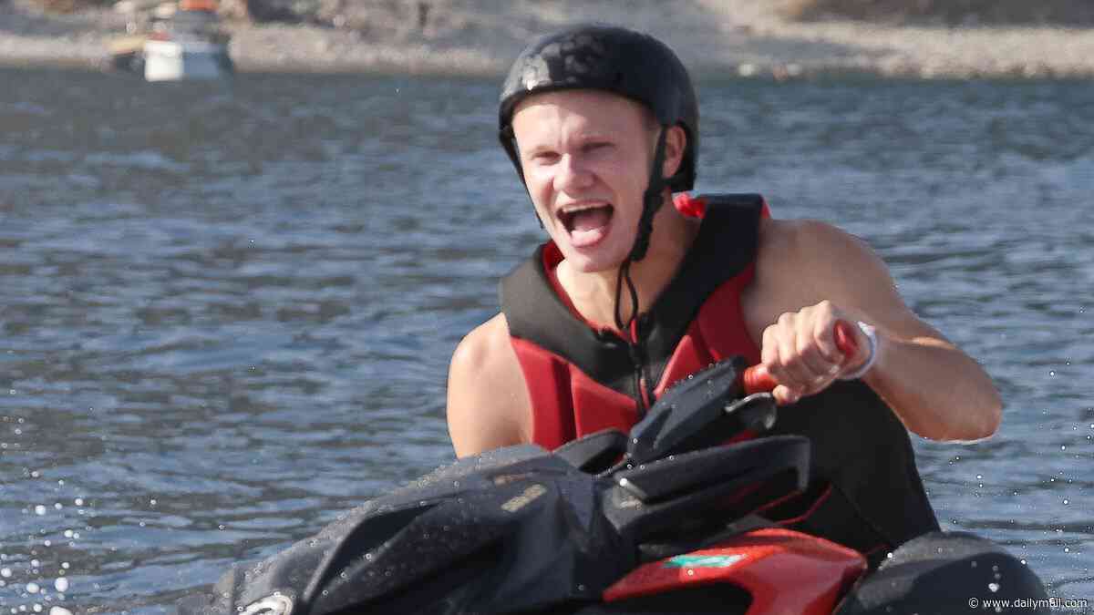 Haaland's summer of fun begins: Shirtless footballer bounces back from World Cup disappointment as he relaxes on a luxury yacht and rides a jet-ski in Sicily after mingling with the A-list at Dolce & Gabbana show