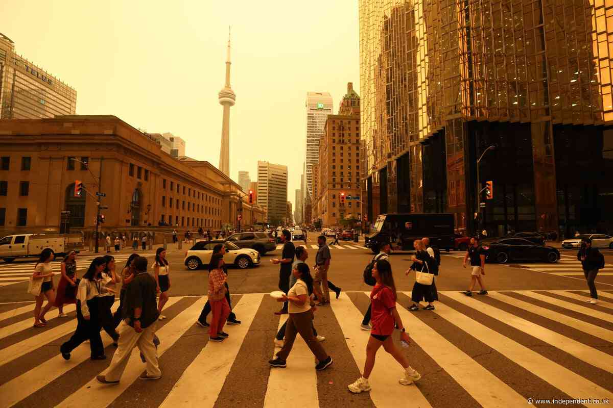 Toronto’s skies turn yellow as dangerous smoke from over 100 wildfires engulfs city