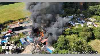 Shipping containers alight in scrapyard fire