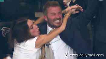 Victoria Beckham leaps into David's arms as she celebrates England's goal after she became an instant meme for failing to react