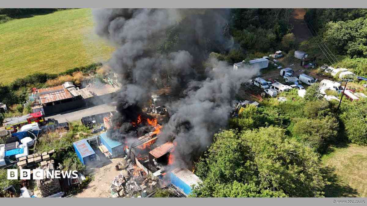 Shipping containers alight in scrapyard fire