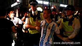 Moment Tiktok prankster wearing Argentina shirt has to be rescued by police from baying mob of England supporters in Piccadilly Circus as World Cup violence spreads across country