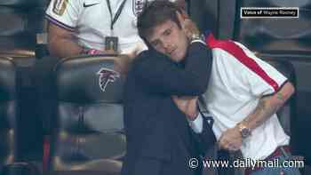 Cruz Beckham wins praise for consoling devastated dad David with a heartfelt hug in 'wholesome' moment as England crashed out of World Cup