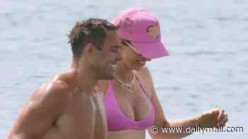 Pregnant Vogue Williams shows off her bump in a pink bikini as she hits the beach with shirtless Spencer Matthews in Spain