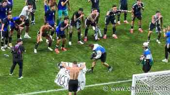 Moment Argentina players put fingers to their lips to silence fans before lifting banner claiming Falkland Islands after they knocked England out of World Cup