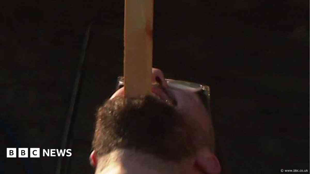 The man who balances bikes, ladders and sheds on his chin