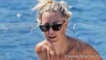 Roxy Jacenko shows off her revised boob job and incredible figure in a bikini while relaxing on a yacht in Italy with her billionaire husband Oliver Curtis and their children