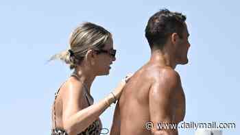 Pregnant Vogue Williams shows off her bump in a leopard print bikini as she enjoys a PDA with Spencer Matthews on the beach in Spain