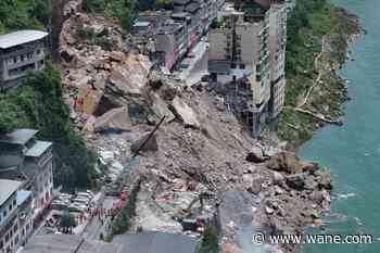 A landslide in southwest China buries homes and forces more than 1,000 to evacuate