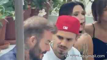 David Beckham jets to New York with son Romeo to attend Victoria's pop-up fragrance launch after she consoled her heartbroken husband during England's World Cup defeat