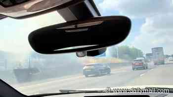 Travel chaos on the M25 as drivers are engulfed by thick smoke after dry fields go up in flames