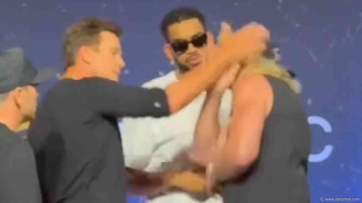 Shocking moment Tom Brady SLAPS Logan Paul as pair reignite their feud at Fanatics Fest... months on from talk of WWE clash
