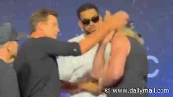 Shocking moment Tom Brady SLAPS Logan Paul as pair reignite their feud at Fanatics Fest... months on from talk of WWE clash