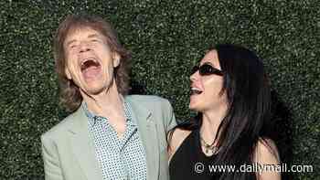 Mick Jagger, 82, can't contain his laughter as he poses with fiancée Melanie Hamrick, 38, at event in California after he was left devastated after England's World Cup defeat