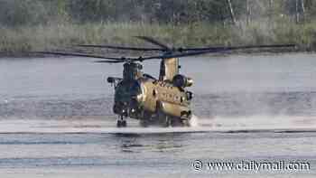 Hair-raising moment RAF Chinook pilot shows incredible skill by hovering just inches above the water to drop off Royal Marines in dramatic training exercise