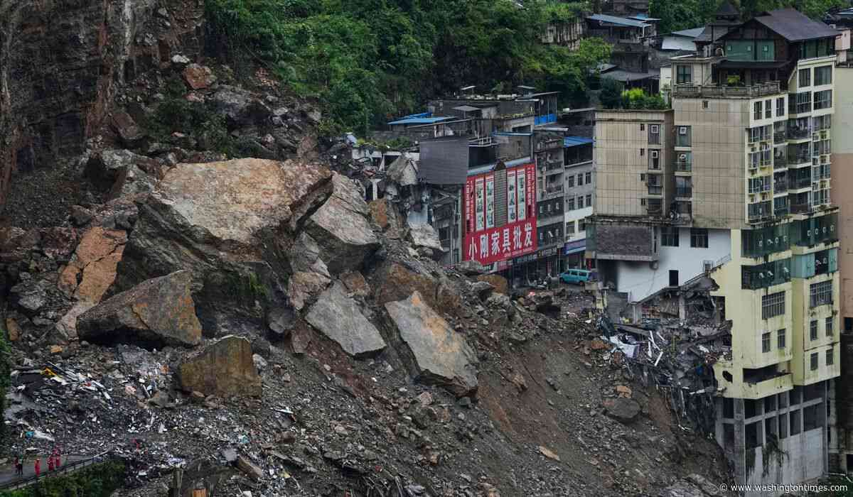 Rescuers race to find survivors in the rain after a landslide in China kills at least 8