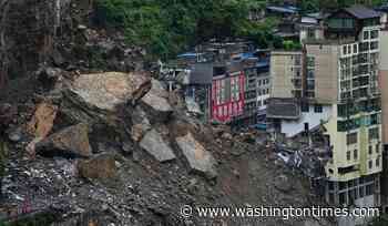 Rescuers race to find survivors in the rain after a landslide in China kills at least 8
