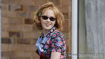 Ellie Bamber swaps Wimbledon chic for a floral-print top and West Ham scarf as she films one of football's craziest ever tales