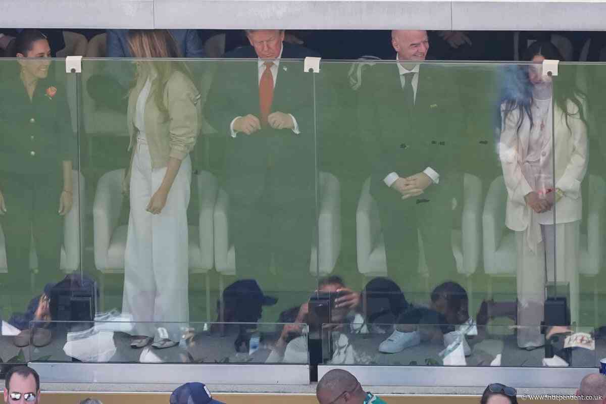 Trump pats FIFA trophy for good luck as he and Melania sit with Infantino behind protective glass at World Cup final
