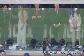 Trump pats FIFA trophy for good luck as he and Melania sit with Infantino behind protective glass at World Cup final