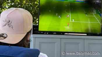 Brooklyn Beckham watches the World Cup final from his sofa at home as his entire family support from the MetLife Stadium - after savage Door Dash ad
