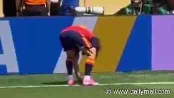 Is this the real reason why Spain won the World Cup? Marc Cucurella spotted burying a 'lucky' COIN in the pitch in secret act seconds before kick-off in New York