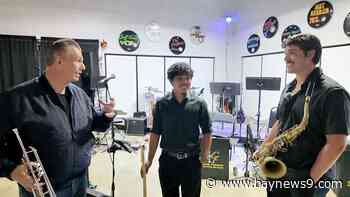 Trumpet player Carl Fischer helps young musicians by having them play in his band