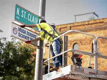 Photo gallery: Crews remove honorary Msgr. Jerome Schmit Way street sign