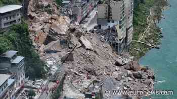 China rescuers race to find trapped people after landslide