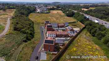 The newbuild housing estate with a 'road to nowhere': Isolated residents are unable to get deliveries after street into 120-home town was left unfinished