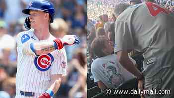 Shocking moment Cubs fan SLAPS young supporter in the stands... after furious tirade during national anthem