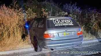 'Durex' BMW gets stuck in hedge after police chase