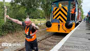 Strongman pulls 64-tonne train along track