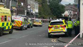 Emergency services swarm Middleton town centre in stand off with man on roof